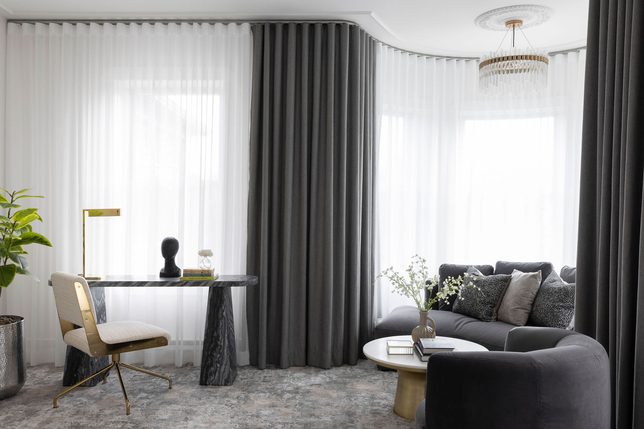 Suite des maîtres lumineuse avec grands rideaux gris pleine hauteur, voilages blancs, coin détente et ambiance douce.